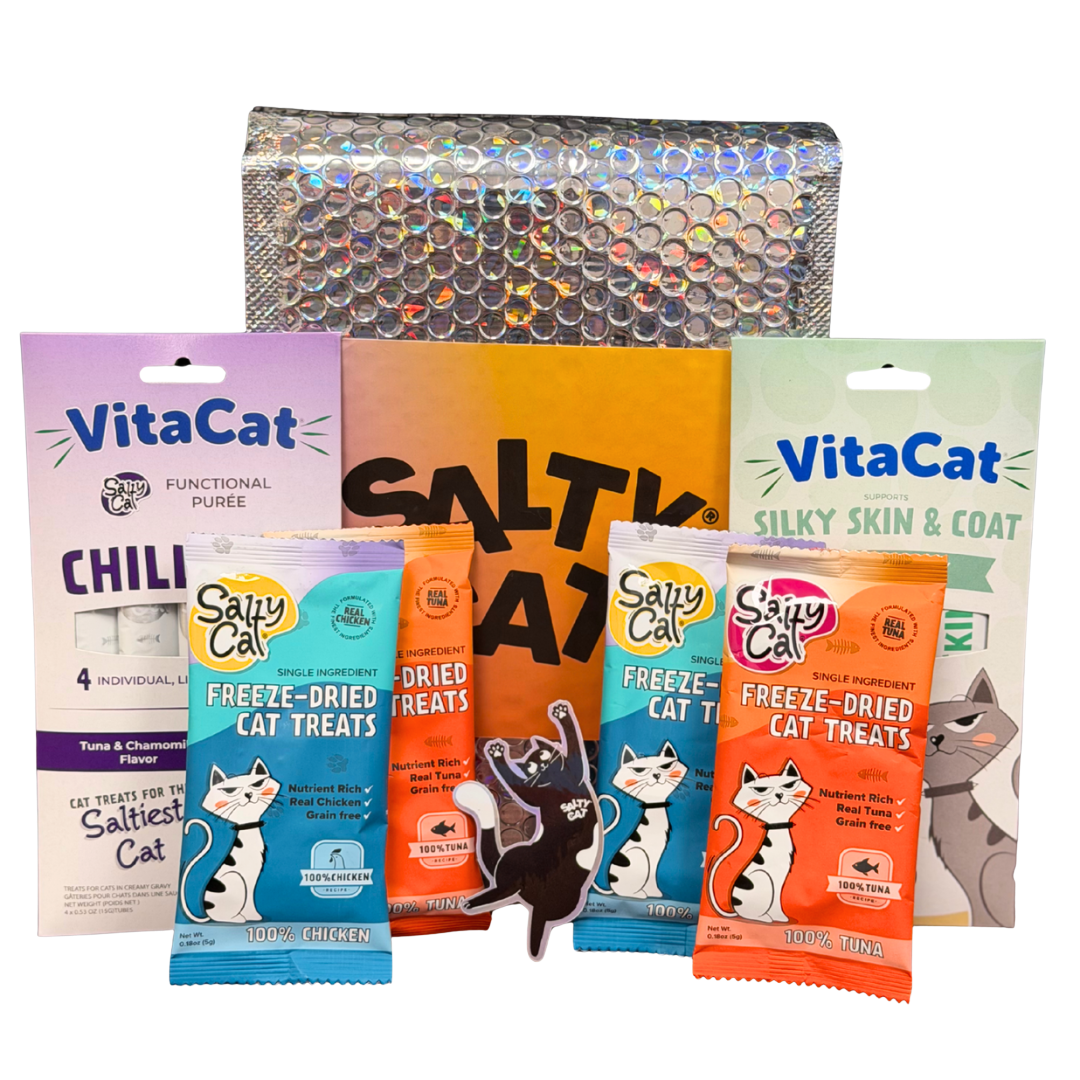 Salty Cat Goodie Bag and VitaCat treats by a shiny, textured bag.