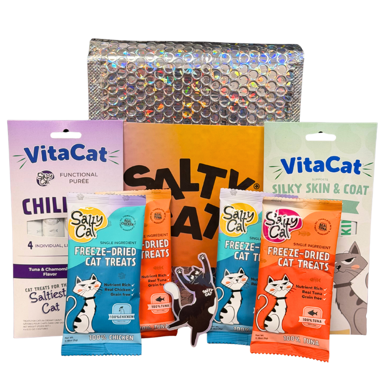 Salty Cat Goodie Bag and VitaCat treats by a shiny, textured bag.