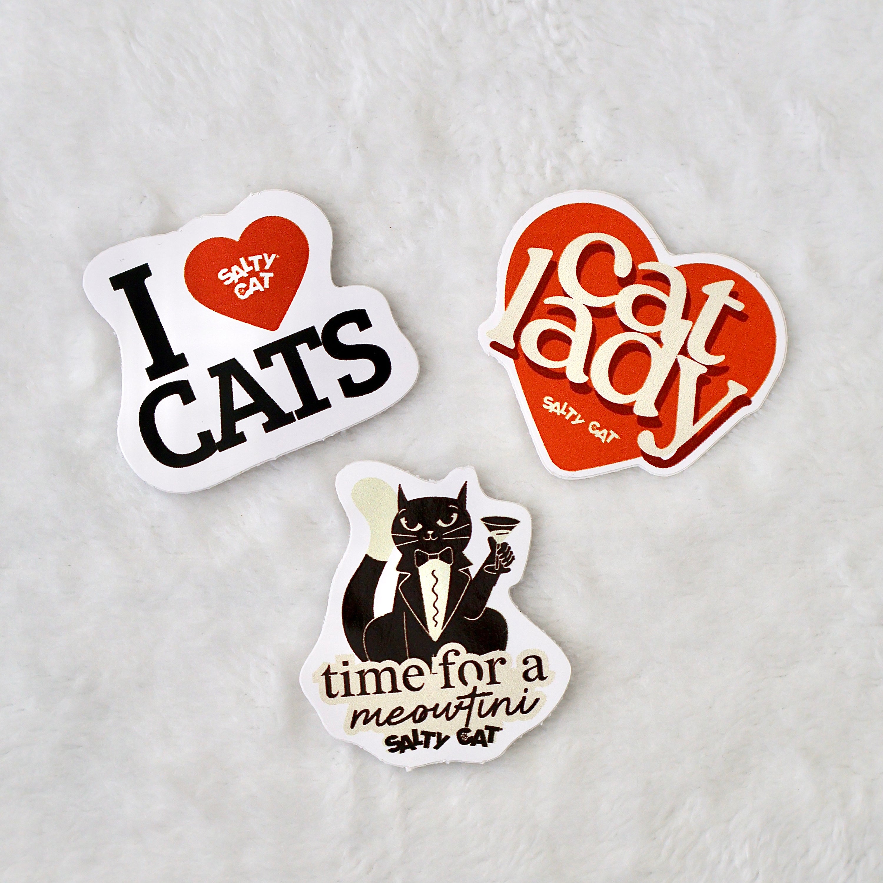 Salty Cat Surprise Sticker Bundle: 3 witty cat-themed stickers, incl. martini cat on white.